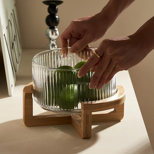 Soda-lime ribbed glass fruit bowl with a cross bamboo base for modern home decor
