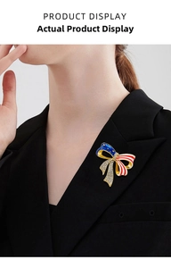 Bowtie brooch with American flag pattern and crystals pinned on a black suit lapel