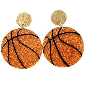 Detailed close-up of basketball-shaped acrylic earrings with orange sequins and gold studs