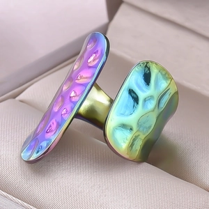 Detail of colorful gradient electroplated stainless steel ring with hammered texture