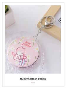 Detail of a mini round pink PU leather folding mirror with cute cartoon cat and daisy
