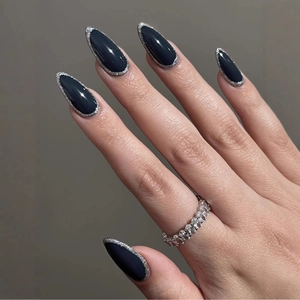 Deep graphite stiletto press-on nails with silver glitter edges and shimmer accents