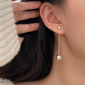 Minimalist 925 sterling silver tassel ball earrings worn by model for a stylish look
