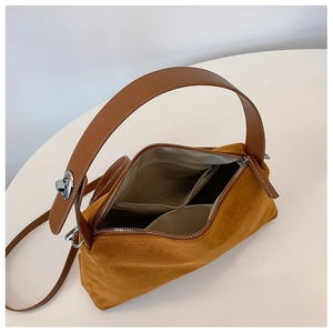 Top view showing the spacious interior and zipper pockets of the brown suede handbag