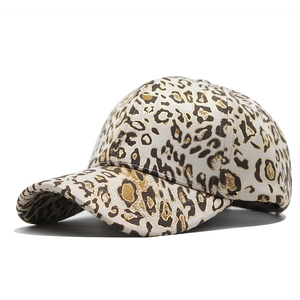 Detail of leopard print baseball cap with gold foil texture and curved brim design