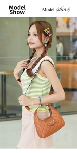 Brown quilted mini hobo bag with a patterned wide strap shown in a street style view