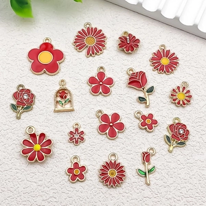 Detailed view of red enamel flower charms and floral alloy pendants for DIY jewelry