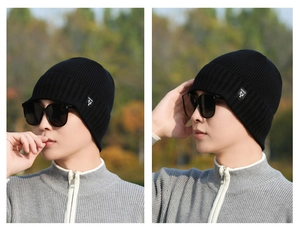 Detail of black knitted beanie featuring thick thermal fabric and a side logo patch