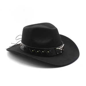 Detailed view of western cowboy hat with metal bull head emblem and bronze rivets on band