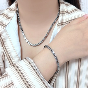 Close-up of heavy duty silver stainless steel chain necklace and bracelet on model