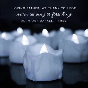 Atmospheric detail of LED electronic candles with cold white light and religious text