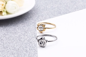 Macro shot of gold and silver flower-shaped rings with sparkling cubic zirconia inlay