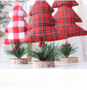 Detailed view of handmade mini fabric Christmas trees with pine needles and wood bases