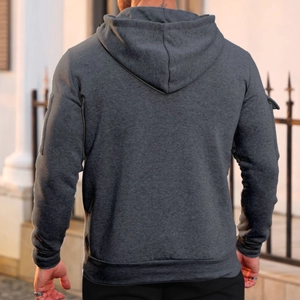 Rear view of dark grey hoodie with ribbed hem and cuffs against outdoor background