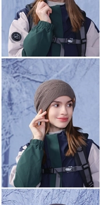 Close-up of the detailed knit pattern and leather patch on a dark brown winter beanie