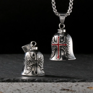 Detail of vintage stainless steel motorcycle bell pendants with cross and wings