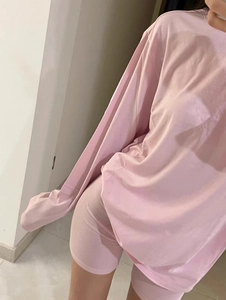 Close-up of pink long-sleeved T-shirt and matching biker shorts lounge set for women