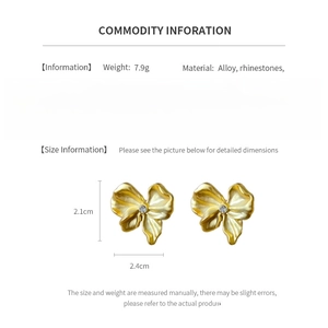 Detail specifications of golden bow earrings with rhinestones showing 2.4cm width and weight
