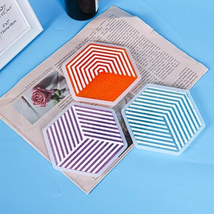 Detailed top view of hexagonal silicone coasters with white geometric stripes and glitter