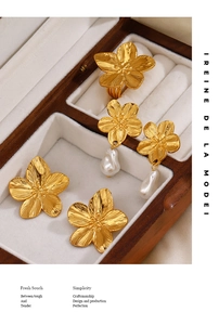 Detailed view of vintage brushed gold flower earrings and ring with baroque pearl in a box