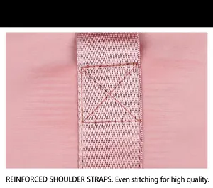 Macro view of reinforced shoulder strap stitching on pink foldable travel gym bag