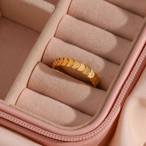 Detailed close-up of a gold-plated fish scale textured ring in a velvet jewelry box