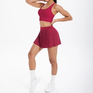 Détail de l'ensemble de sport bordeaux avec brassière croisée et mini-jupe plissée