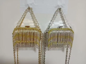 Detail of luxury acrylic evening clutch bags with sparkling rhinestones and metal tassels