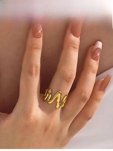 Close-up of 18K gold plated wavy liquid metal ring worn on finger for modern style