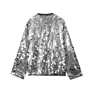 Close-up of sparkling silver sequins stitched on a fashion blouse for women