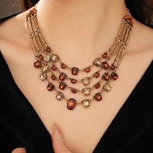 Detail of vintage bronze multi-layer necklace with amber and olive green stones