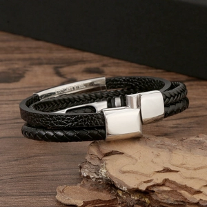 Men's multilayer black braided leather bracelet with stainless steel cross on wood