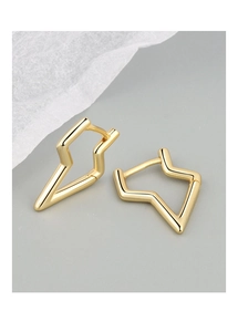 Detailed macro view of geometric lightning bolt earrings in polished gold finish