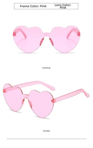 Close-up of pink heart-shaped rimless sunglasses showing lens detail and metallic hinges