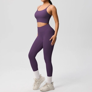 Detail of high-stretch dark purple yoga set with cross-back sports bra and high-waist leggings