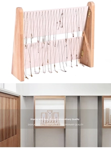 Macro detail of wooden double-row necklace display rack with soft pink velvet lining