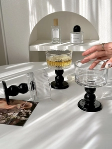 Detailed close-up of ribbed glass dessert cup with stylish black bubble stem design