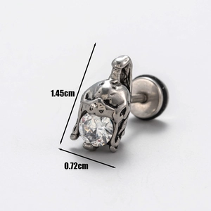 Macro shot of stainless steel earring featuring skull helmet design and cubic zirconia