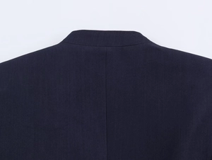 Close-up of navy blue blazer collar and fine texture of the combed fabric material