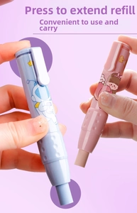 Close-up of retractable push-type pen eraser showing astronaut and bunny theme designs