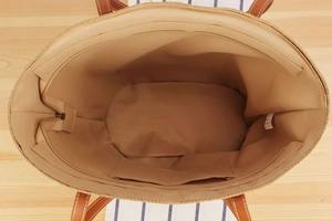 Top view of striped tote bag interior showing brown lining, zipper pocket and large capacity