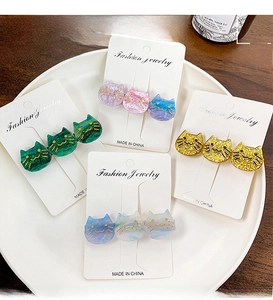 Detail of cute acetate cat hair clips with glitter accents in various colors