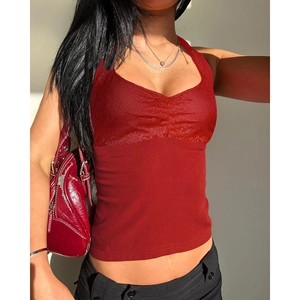 Detail view of red halter top featuring rose lace splicing and ruched chest design