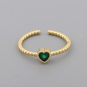 Detailed close-up of a 18k gold-plated ring featuring a green heart-shaped crystal stone