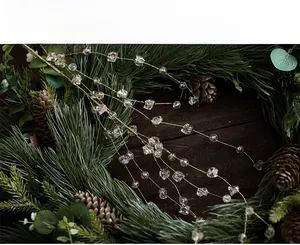 Detail of Christmas beaded garland with clear faceted crystals on gold wire and pine cones