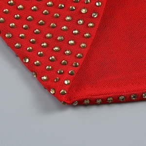 Close-up of red mesh fabric with sparkling champagne rhinestones and detailed stitching