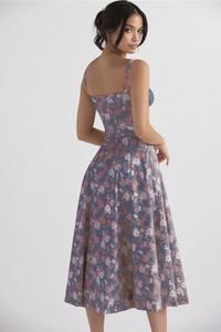 Detail view of the floral summer dress featuring an open back and flowing maxi skirt