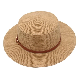 Detail of flat top straw hat with brown leather belt and golden buckle on wide brim