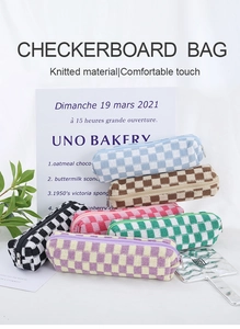 Detailed pile of multi-color knitted checkerboard pencil cases in various vibrant tones
