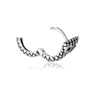 Vintage silver snake ear cuff with black gemstones on a reflective white background